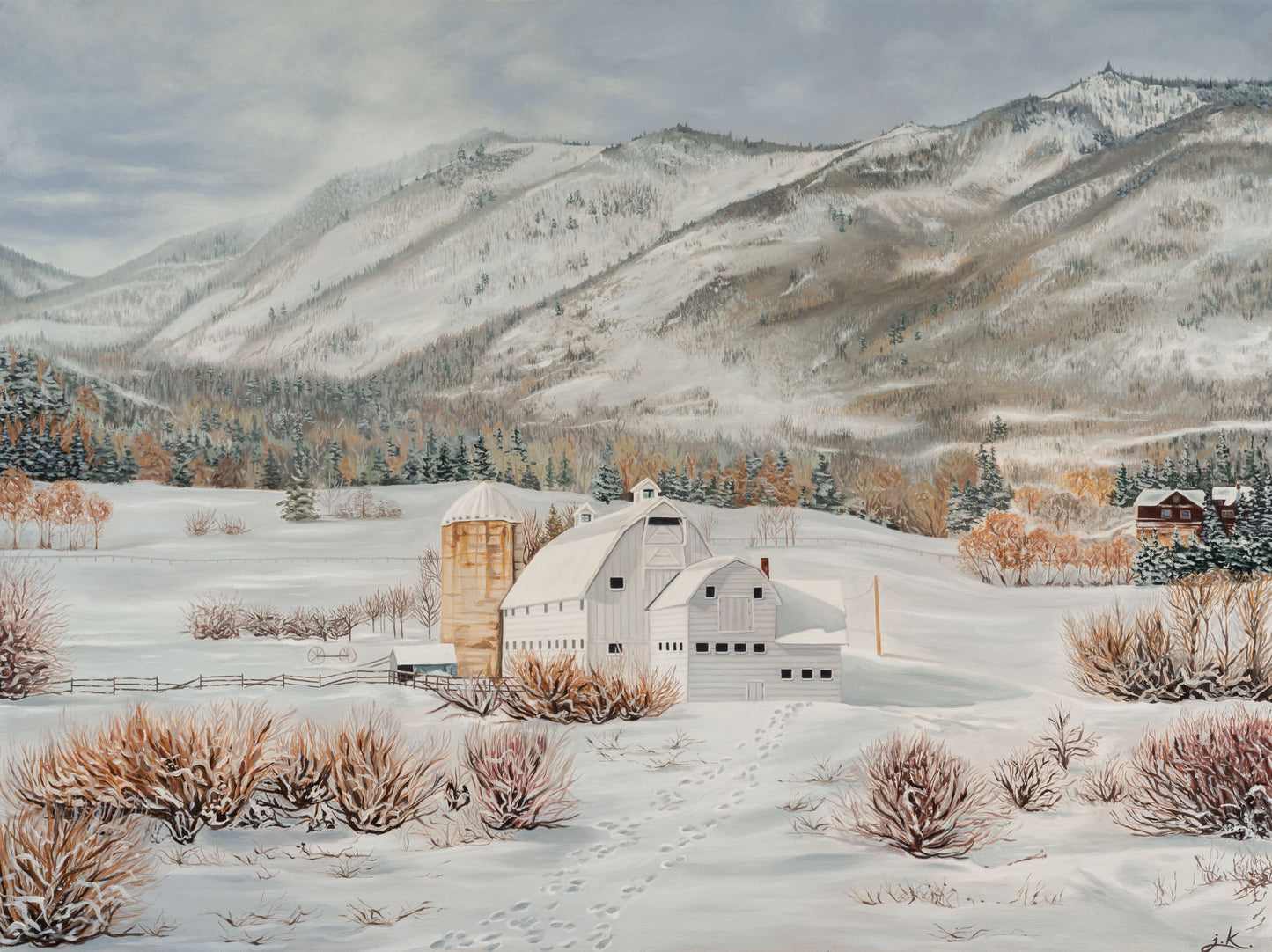 Winter landscape with a barn, silo, and snow-covered mountains.